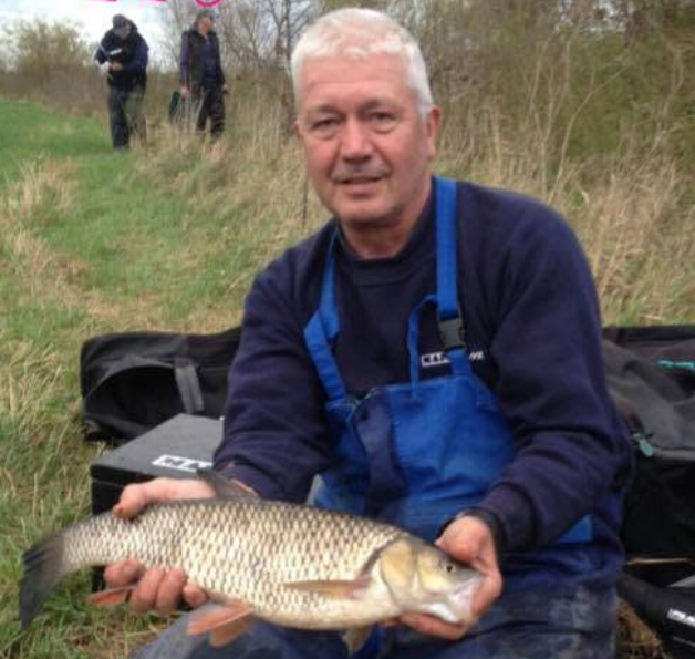 the-story Jim Burton with a chub caught while fishing